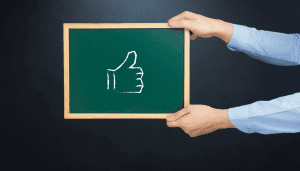 Thumbs up picture on a black board